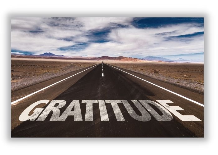 gratitude in large white painted letters on road